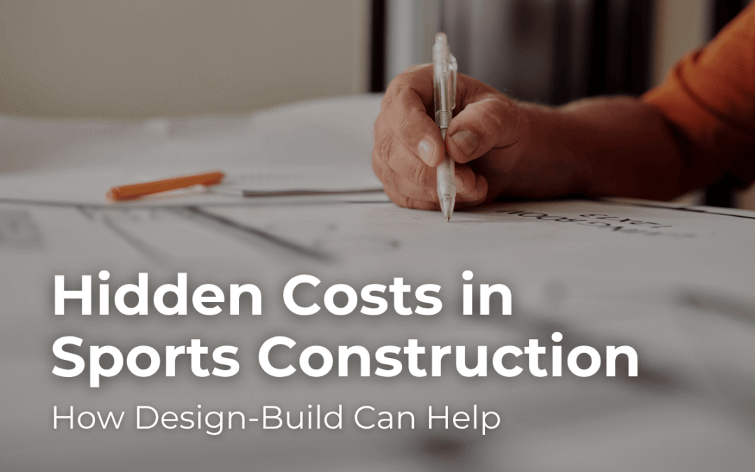 Hand writing on construction plans with text overlay "Hidden Costs in Sports Construction" and "How Design-Build Can Help," relevant to sports facility project insights.