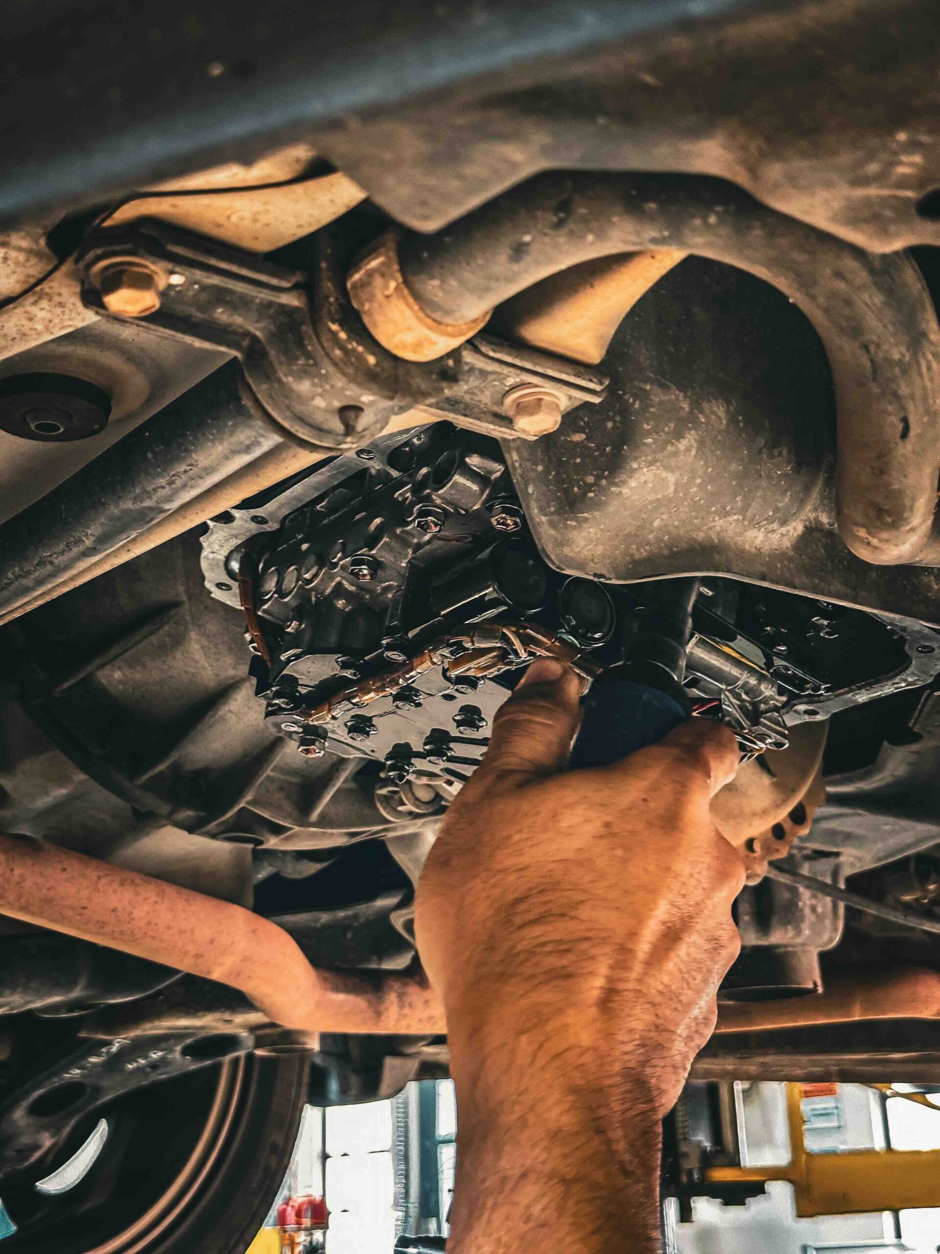 Mechanic working on heavy equipment engine, performing diagnostics and repairs.